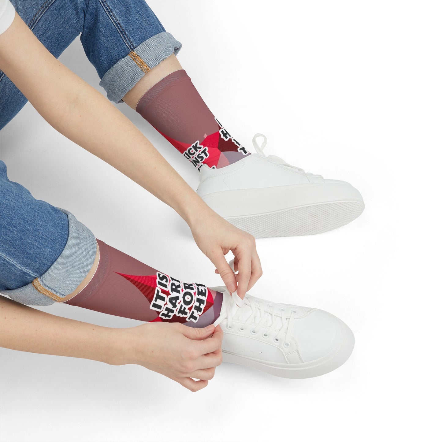 Woman tying shoes wearing Kick Against the Pricks bible verse socks